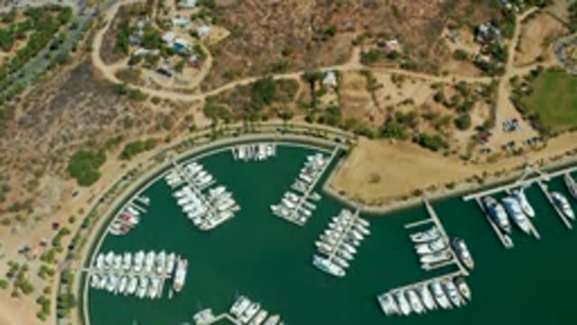 PUERTO LOS CABOS BCS MEXICO-2022: Marina with Docked Boats and Hillside Terrain