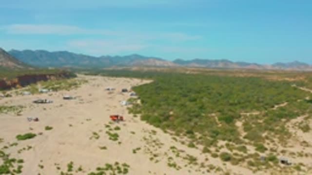 LOS FRAILES LOS CABOS BCS MEXICO-2022: Truck Moving Across Sandy Desert Landscape