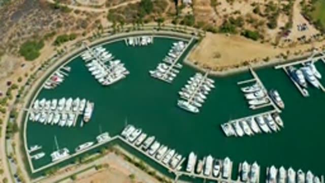 PUERTO LOS CABOS BCS MEXICO-2022: Boats Entering and Exiting a Curved Marina Dock