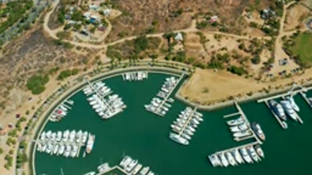 PUERTO LOS CABOS BCS MEXICO-2022: Marina with Boats and a Departing Vessel