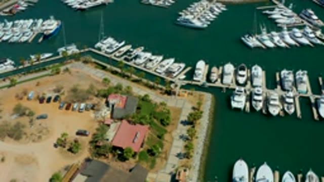 PUERTO LOS CABOS BCS MEXICO-2022: Marina with Docked Boats and Parking Lot Vehicle Activity
