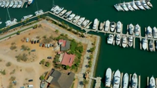 PUERTO LOS CABOS BCS MEXICO-2022: Marina and Parking Lot with Moving Boats and Departing Cars