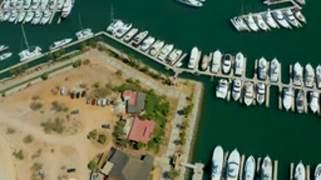 PUERTO LOS CABOS BCS MEXICO-2022: Marina with Departing Boat and Parking Lot Activity