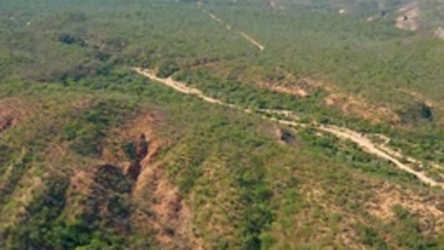 EL SALADO VIEJO LOS CABOS BCS MEXICO-2022: Vehicle Moving Along Winding Dirt Road in Hilly Landscape
