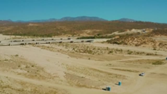 EL TULE LOS CABOS BCS MEXICO-2022: Car Moving on Desert Dirt Road with Highway