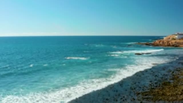 EL TULE LOS CABOS BCS MEXICO-2022: Waves Crashing on Rocky Shore with Turquoise Ocean