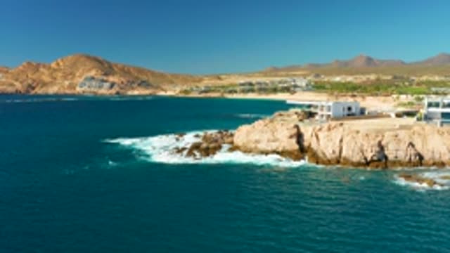 CHILENO BEACH LOS CABOS BCS MEXICO-2022: Waves Crashing on Rocky Coastal Cliffside