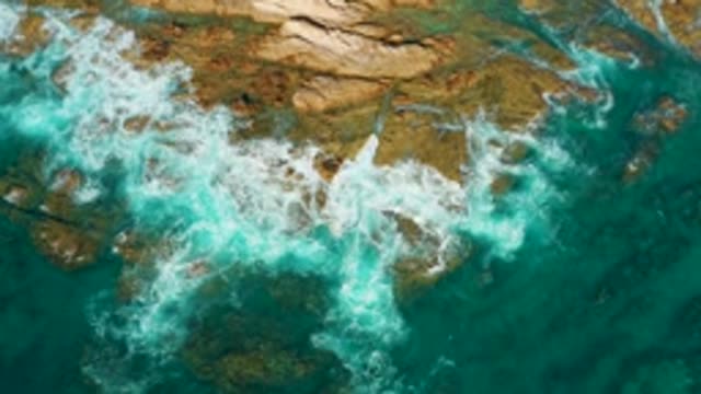 CHILENO BEACH LOS CABOS BCS MEXICO-2022: Waves Crashing Against Rocky Shoreline