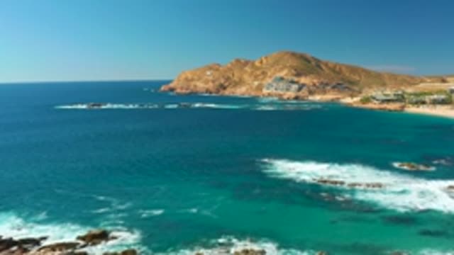 CHILENO BEACH LOS CABOS BCS MEXICO-2022: Waves Crashing on Rocky Coastline with Turquoise Water