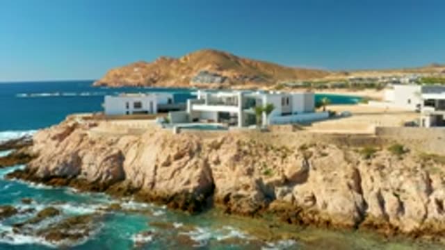 CHILENO BEACH LOS CABOS BCS MEXICO-2022: Coastal Road with Car Driving Past Cliffside Homes