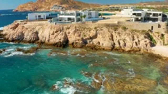 CHILENO BEACH LOS CABOS BCS MEXICO-2022: White Buildings on Rocky Coastal Cliff Overlooking Turquoise Water