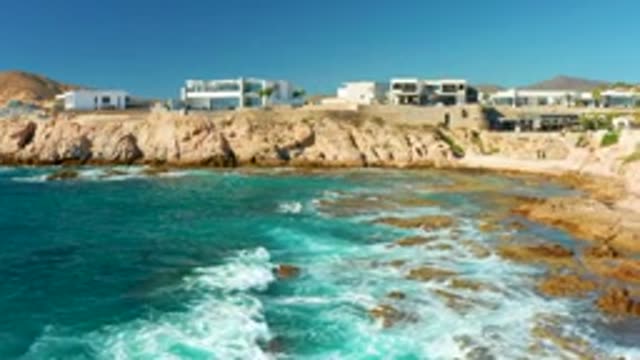 CHILENO BEACH LOS CABOS BCS MEXICO-2022: Coastal Cliff with Buildings and Calming Ocean Waves