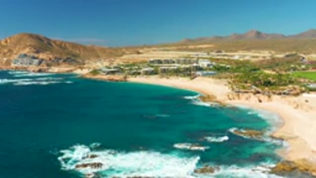 CHILENO BEACH LOS CABOS BCS MEXICO-2022: Waves Breaking on Rocky Coastline with Sandy Beach