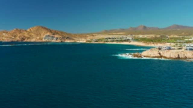CHILENO BEACH LOS CABOS BCS MEXICO-2022: Gentle Ocean Waves on Rocky Coast with Sandy Beach