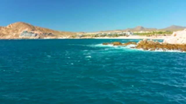 CHILENO BEACH LOS CABOS BCS MEXICO-2022: Ocean Waves Crashing Against Rocky Shoreline