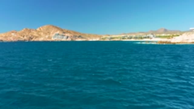 CHILENO BEACH LOS CABOS BCS MEXICO-2022: Calm Ocean Waves Along Mountainous Coastline