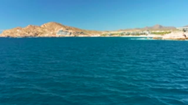 CHILENO BEACH LOS CABOS BCS MEXICO-2022: Coastal Ocean View with Rocky Hills and Buildings