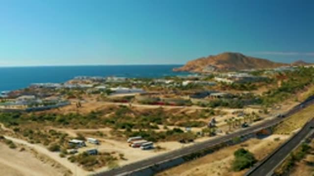 CHILENO BEACH LOS CABOS BCS MEXICO-2022: Vehicles Moving on Coastal Highway by Ocean
