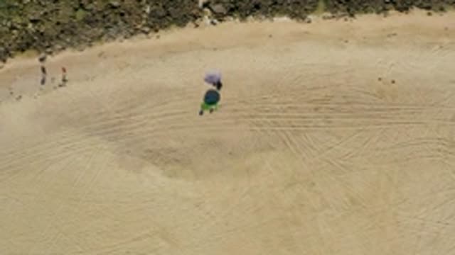 CHILENO BEACH LOS CABOS BCS MEXICO-2022: Overhead View of Beachgoers Walking on Sandy Shore