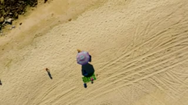 CHILENO BEACH LOS CABOS BCS MEXICO-2022: Person Walking on Sandy Beach Near Umbrella