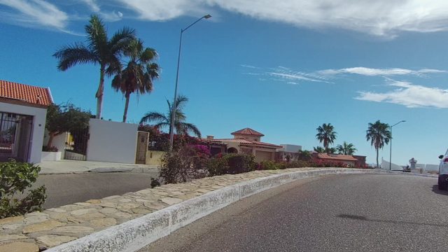 EAST CAPE LOS CABOS BCS MEXICO-2022: Residential Street with Red-Tiled Roofs and Palm Trees