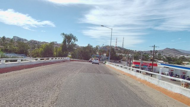 EAST CAPE LOS CABOS BCS MEXICO-2022: Vehicles Traveling on a Curving Road Bridge
