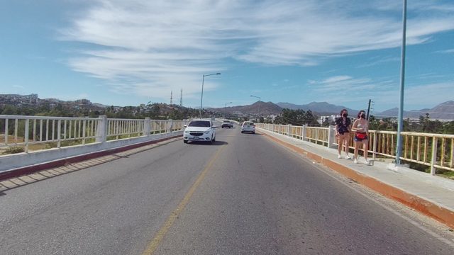 EAST CAPE LOS CABOS BCS MEXICO-2022: Vehicles and Pedestrians on a Bridge Road