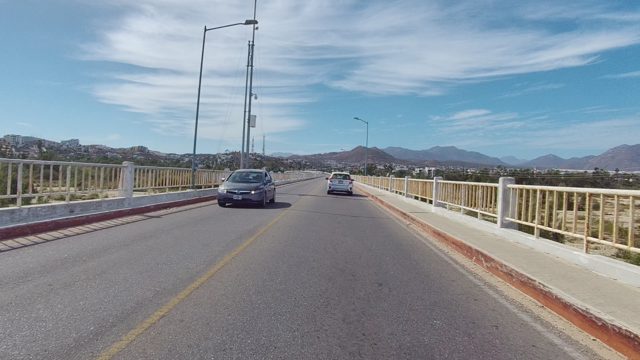 EAST CAPE LOS CABOS BCS MEXICO-2022: Vehicles Traveling on a Bridge with Mountain Background