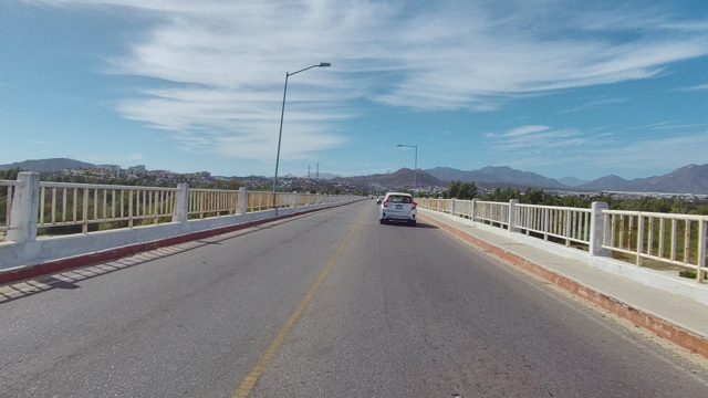 EAST CAPE LOS CABOS BCS MEXICO-2022: Car Moving Along a Bridge with Mountain View
