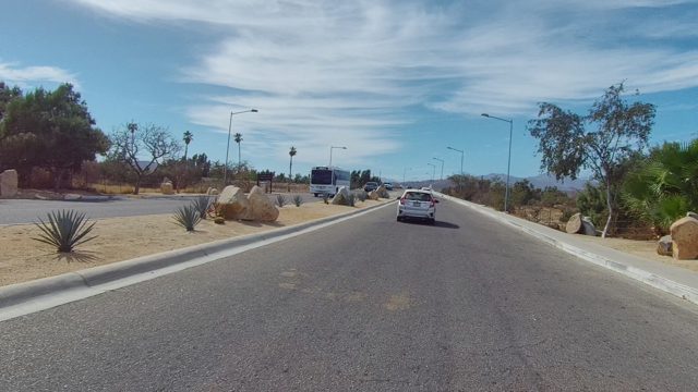 EAST CAPE LOS CABOS BCS MEXICO-2022: Vehicles Traveling on a Desert Road with Sparse Vegetation