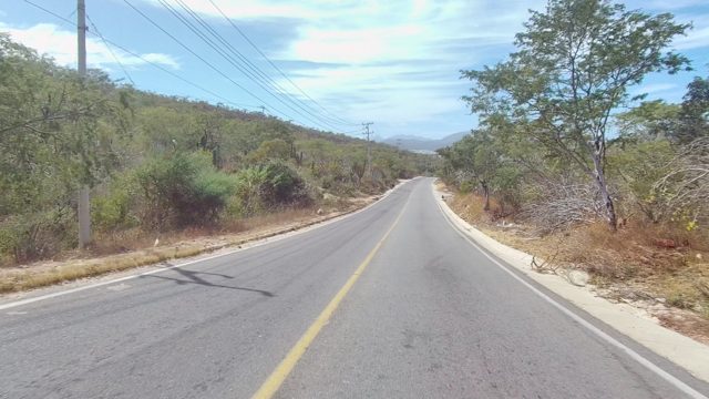 EAST CAPE LOS CABOS BCS MEXICO-2022: Two-Lane Road Through Arid Hilly Landscape