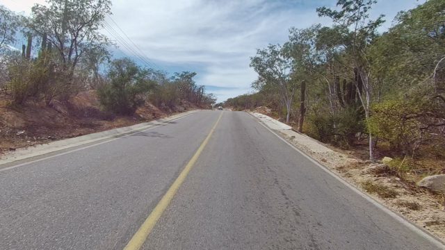 EAST CAPE LOS CABOS BCS MEXICO-2022: Two-Lane Road Through Arid Hills with Oncoming Vehicle