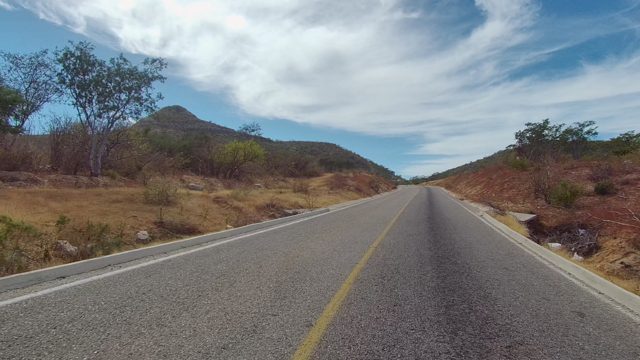 EAST CAPE LOS CABOS BCS MEXICO-2022: Road Through Arid Hills and Sparse Vegetation
