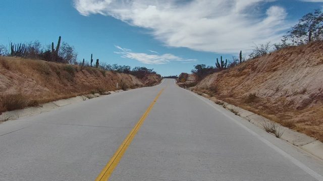 EAST CAPE LOS CABOS BCS MEXICO-2022: Road Through Arid Landscape with Cacti