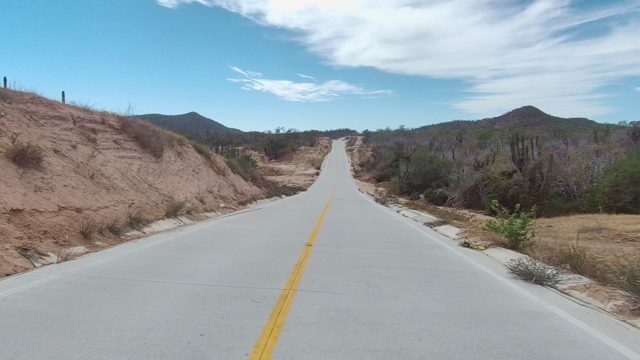 EAST CAPE LOS CABOS BCS MEXICO-2022: Road Through Arid Hills and Sparse Vegetation