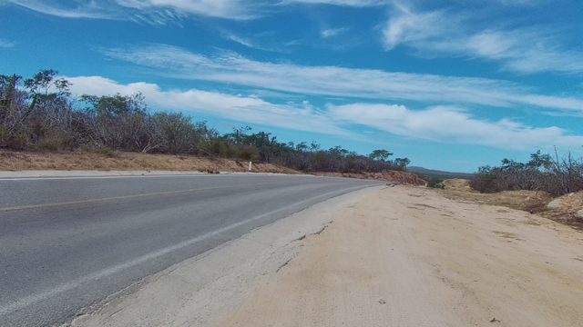 EAST CAPE LOS CABOS BCS MEXICO-2022: Forward View of Paved Road with Arid Landscape