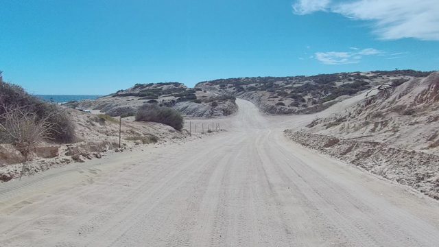 EAST CAPE LOS CABOS BCS MEXICO-2022: Dirt Road Through Arid Desert Landscape