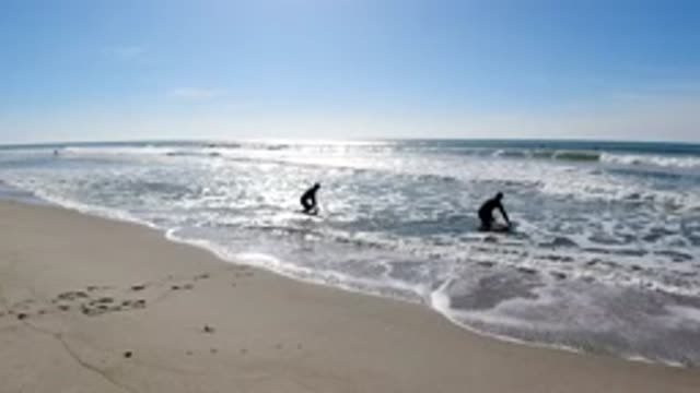 TRESTLES BEACH CALIFORNIA-2019: Surfers Getting Into The Water At The Shore Of
