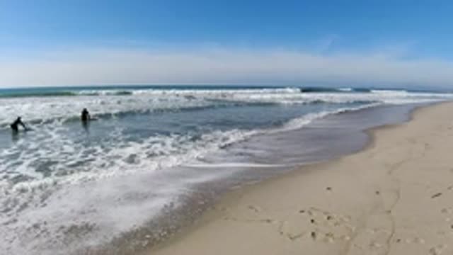 TRESTLES BEACH CALIFORNIA-2019: Beach-Goers Play With Boogie Boards As Tide