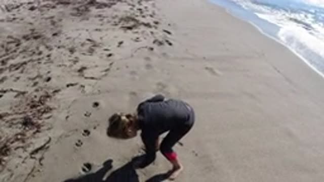 TRESTLES BEACH CALIFORNIA-2019: Little Girl Playing On The Shore Of The Ocean On