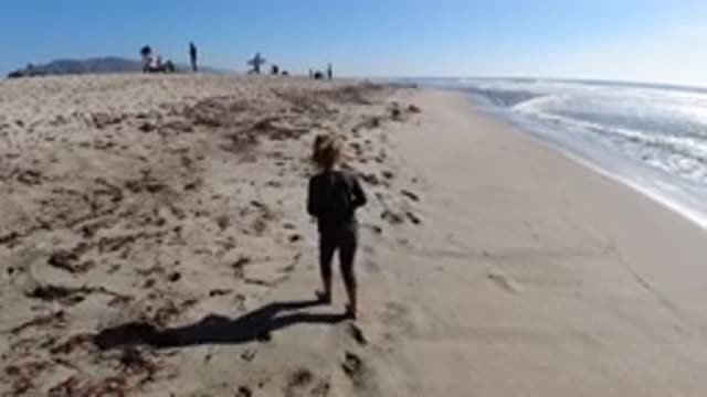 TRESTLES BEACH CALIFORNIA-2019: Little Kid Finds and Picks a Shell on the Beach