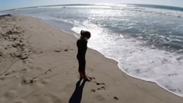 TRESTLES BEACH CALIFORNIA-2019: Child Playing in Waves at the Beach