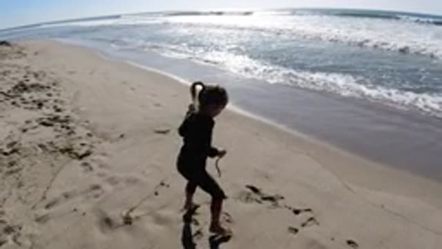 TRESTLES BEACH CALIFORNIA-2019: Little Girl Jumping on Sunny Beach