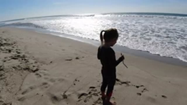 TRESTLES BEACH CALIFORNIA-2019: Little Girl Standing In The Sand On The Shore
