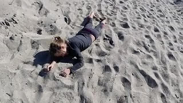 TRESTLES BEACH CALIFORNIA-2019: A Young Girl Playing In The Sand On A Bright And