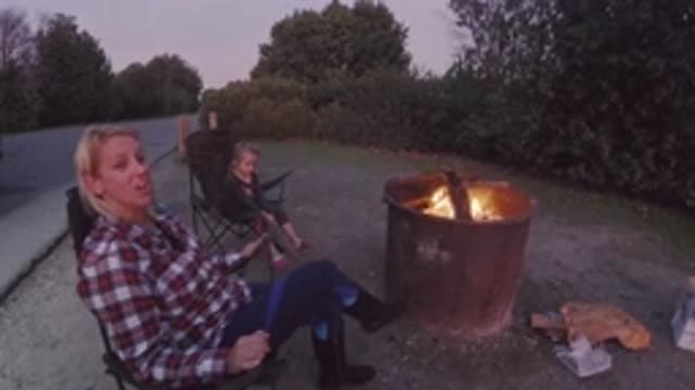 TRESTLES BEACH CALIFORNIA-2019: A Child And Her Mother Are Sitting Next To A Bonfire