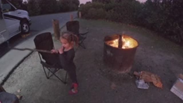 TRESTLES BEACH CALIFORNIA-2019: Little Girl Playing With Stick Outside Of Fire
