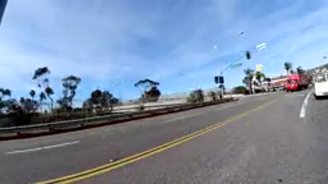 SAN CLEMENTE CALIFORNIA-2019: Vehicle Moves Down City Street Palm Trees Line