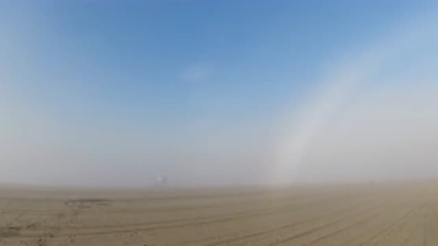 HUNTINGTON BEACH CALIFORNIA-2019: Slow Pan Of Desert With What Appears To Be A White Rainbow