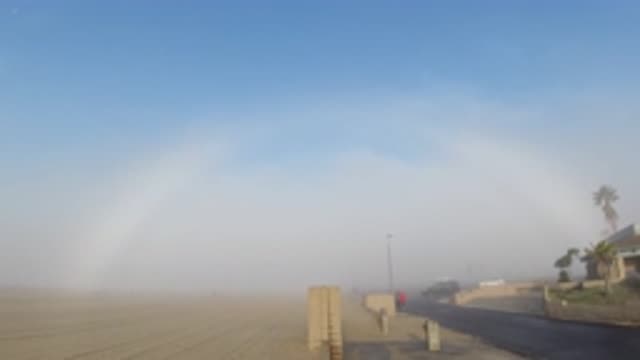 HUNTINGTON BEACH CALIFORNIA-2019: A Clear Bright Blue Sky From A Sandy Landscape